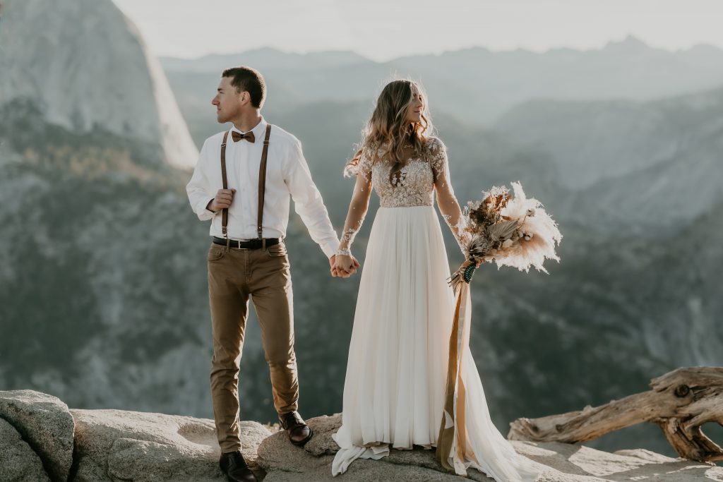 Bride and groom at Glacier Point, Yosemite with Half Dome in the distance. Be fearless in pursuit of your dreams
